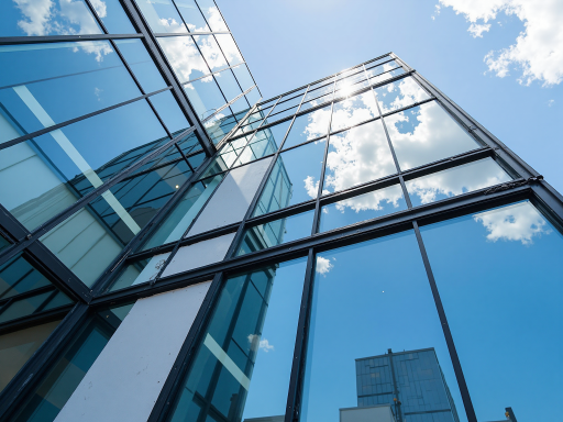 建筑公司外立面,现代化办公楼,蓝天白云背景,专业施工设备停放区域,体现企业实力